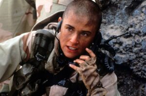 Female soldier in desert camouflage armor crouches, speaking on a radio handheld to communicate on the battlefield
