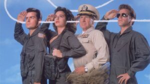 Group of four people in military-style outfits saluting, standing side by side against a blue sky backdrop (one woman center, a senior officer in tan uniform).